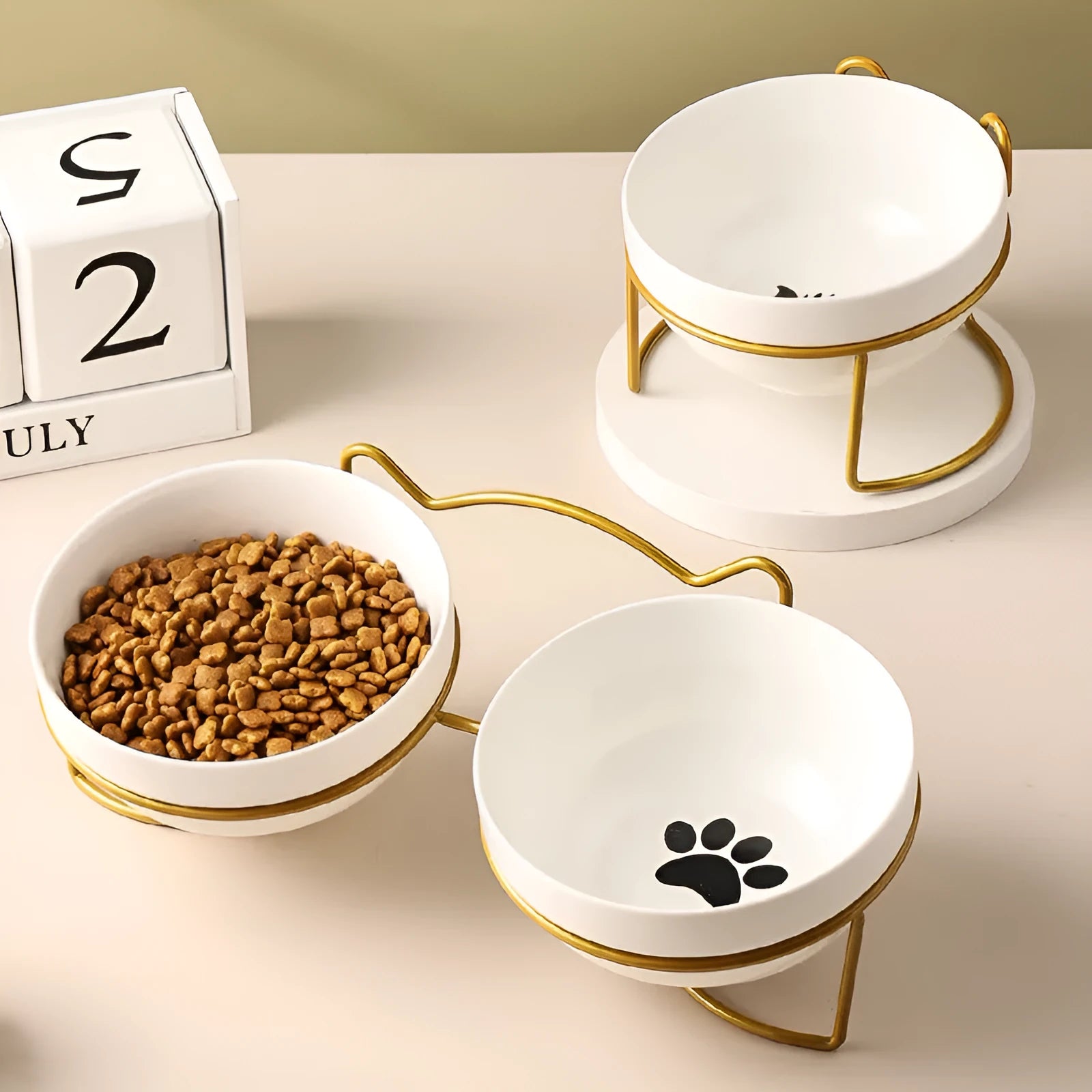 White ceramic cat bowl with decorative iron frame in cat footprints pattern