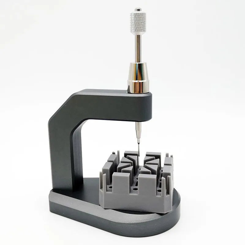 Silver-coloured press strap removal tool made from tool steel for watch and electronics repair.