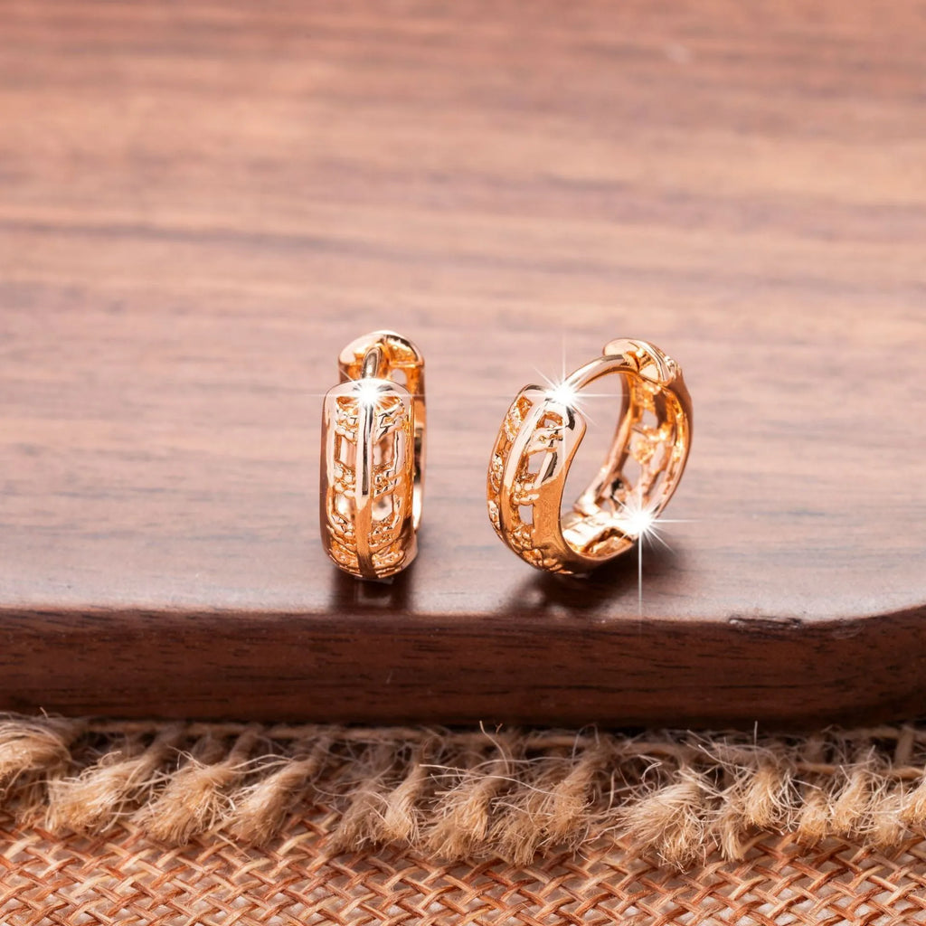 Rose gold hollowed leaf and heart shaped copper earrings on display