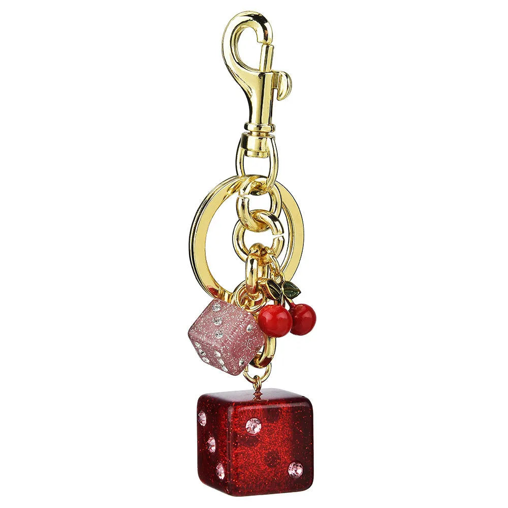 Square metal keychain pendant with a vintage cherry red and white dice design.