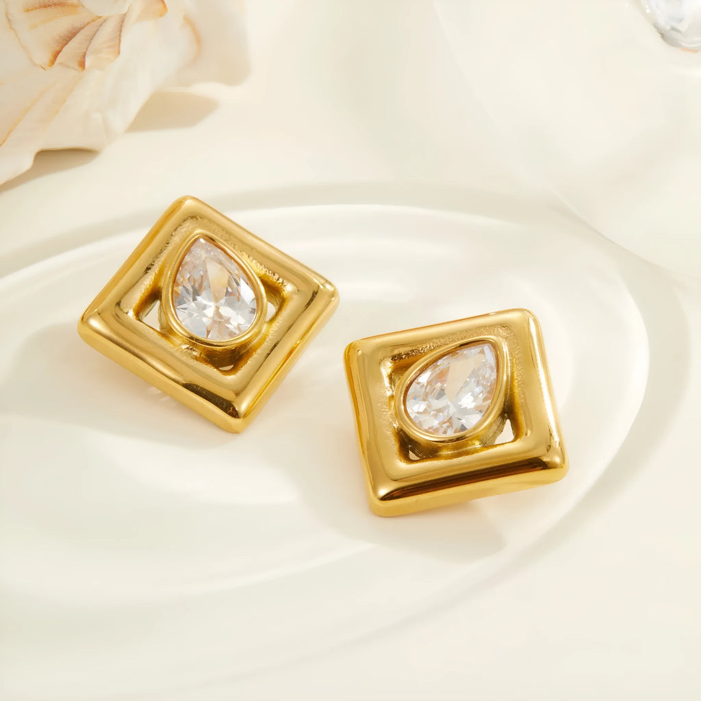 Gold coloured geometric stud earrings with an inlaid water drop zircon stone.
