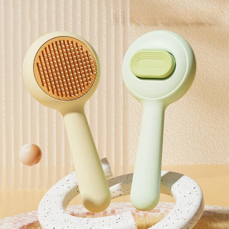 Green and yellow stainless steel pet grooming brush with a non-slip handle for hair removal.