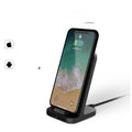 Dark grey vertical wireless charging stand for Apple iPhone on desk
