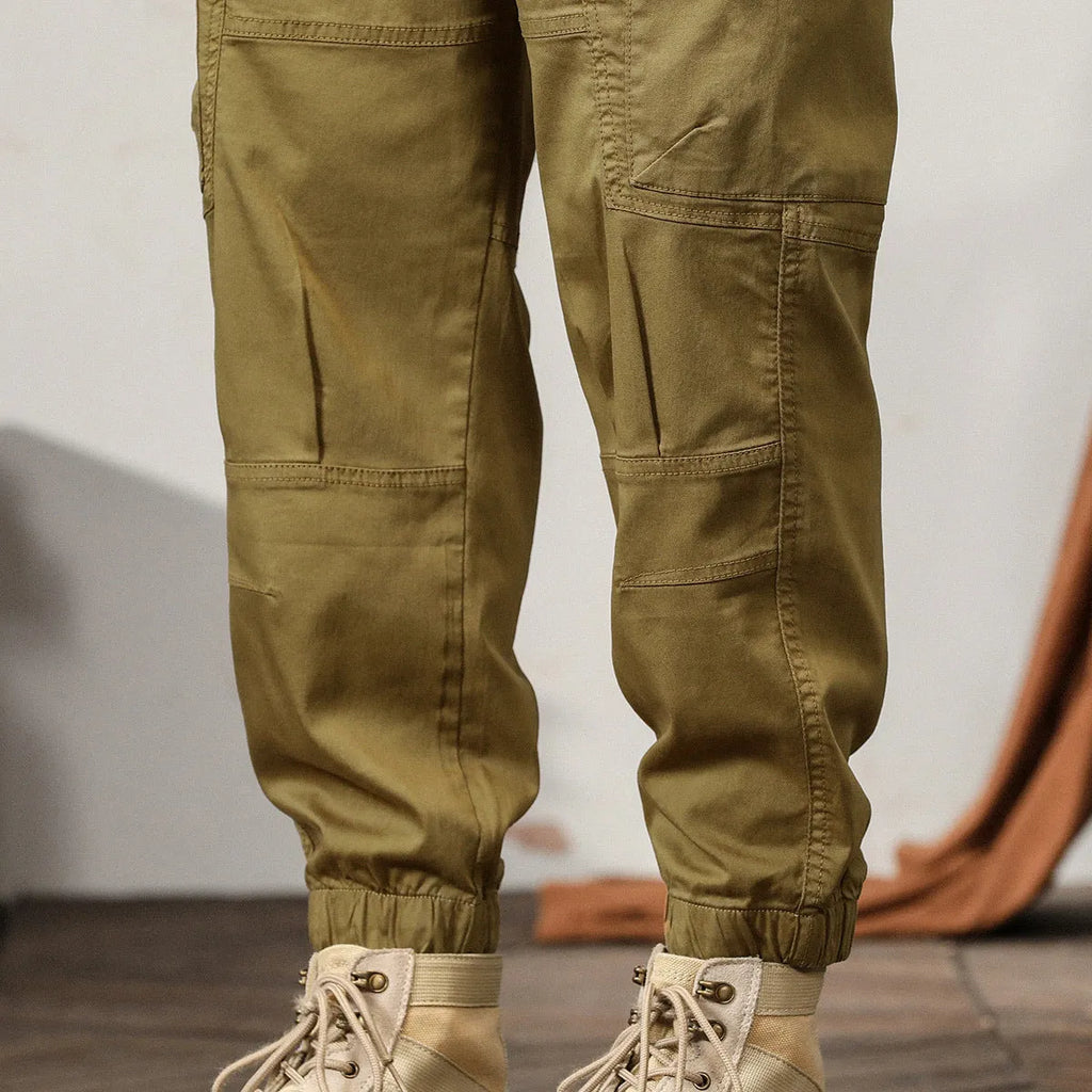 Men's khaki cotton harem pants with tapered ankle band and zip placket front view