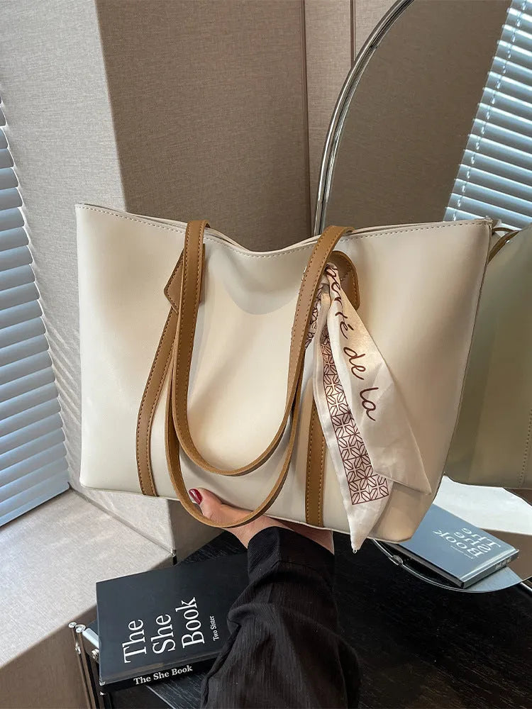 Large bucket-style tote bag with crossbody strap shown in multiple colour options