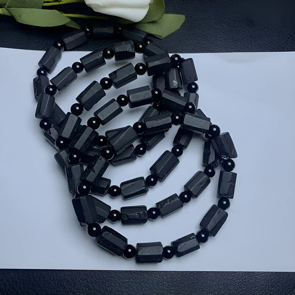 Natural black tourmaline rough stone bracelet with 10mm beads showing textured stone surfaces