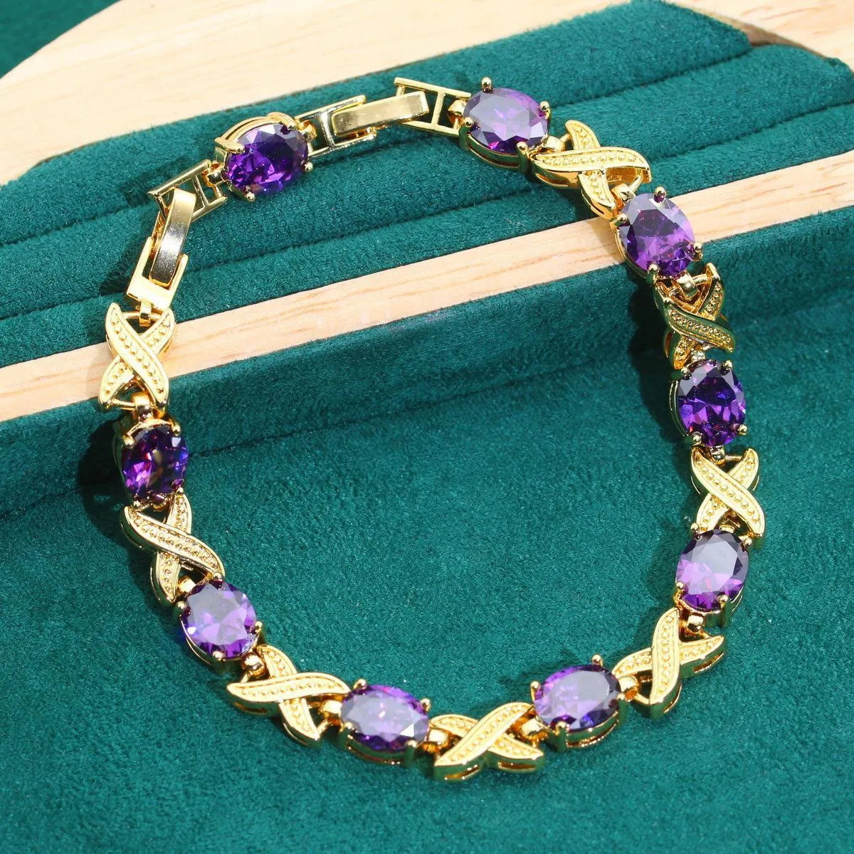 18k gold plated jewellery set with blue synthetic cubic zirconia stones, showing necklace, earrings, ring, and bracelet.
