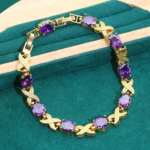 18k gold plated jewellery set with blue synthetic cubic zirconia stones, showing necklace, earrings, ring, and bracelet.