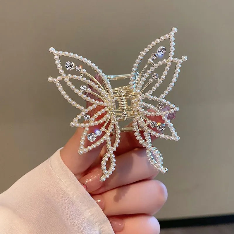 Butterfly-shaped alloy hair clip barrette for women, available in rhinestone and pearl styles.