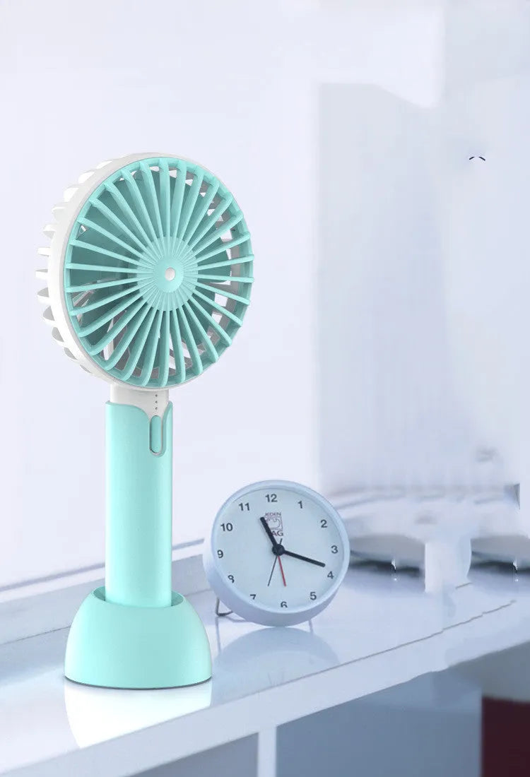 Blue handheld mini electric fan with USB cable, three speed buttons, and shaking head function