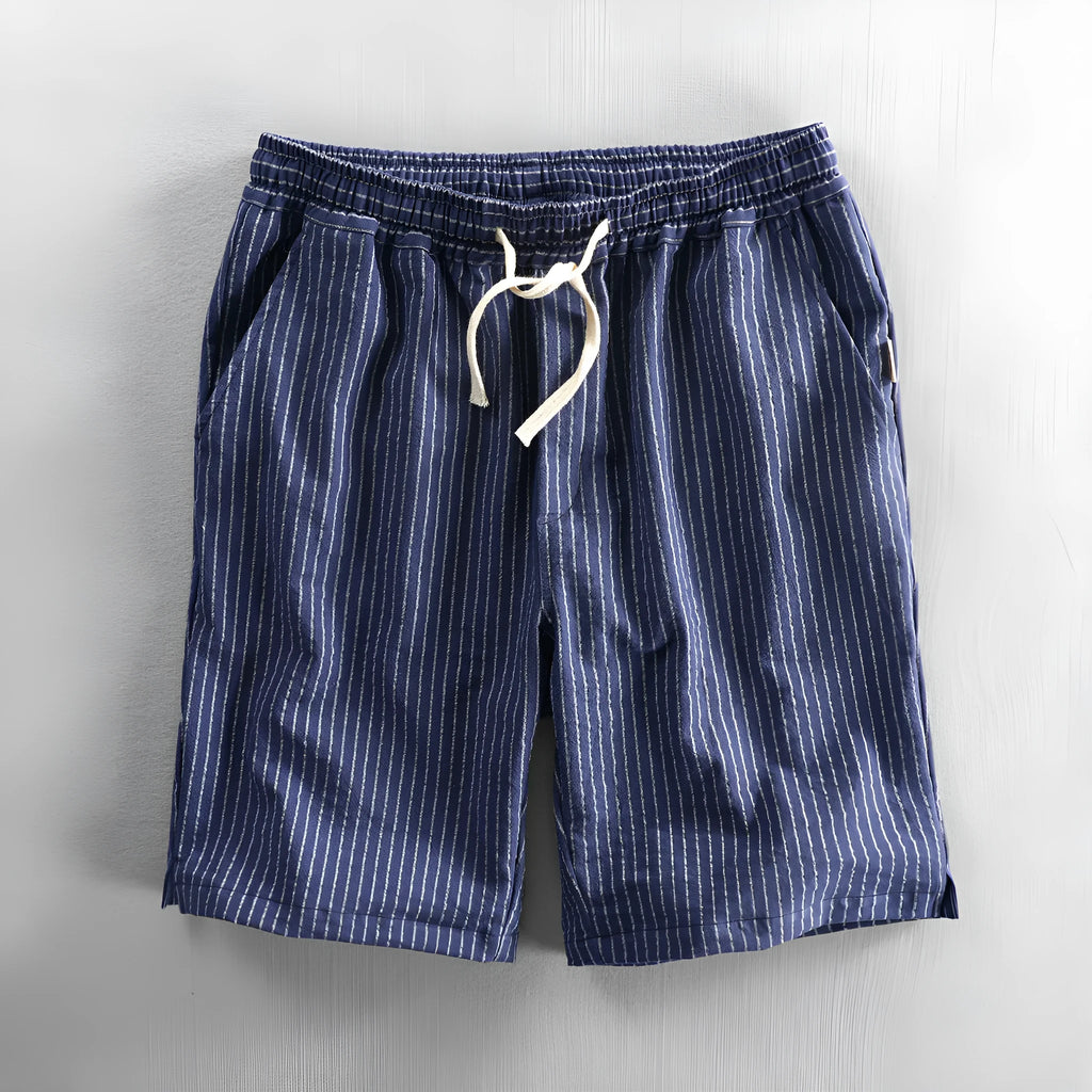 Man wearing black and white striped cotton casual shorts with a loose straight fit.