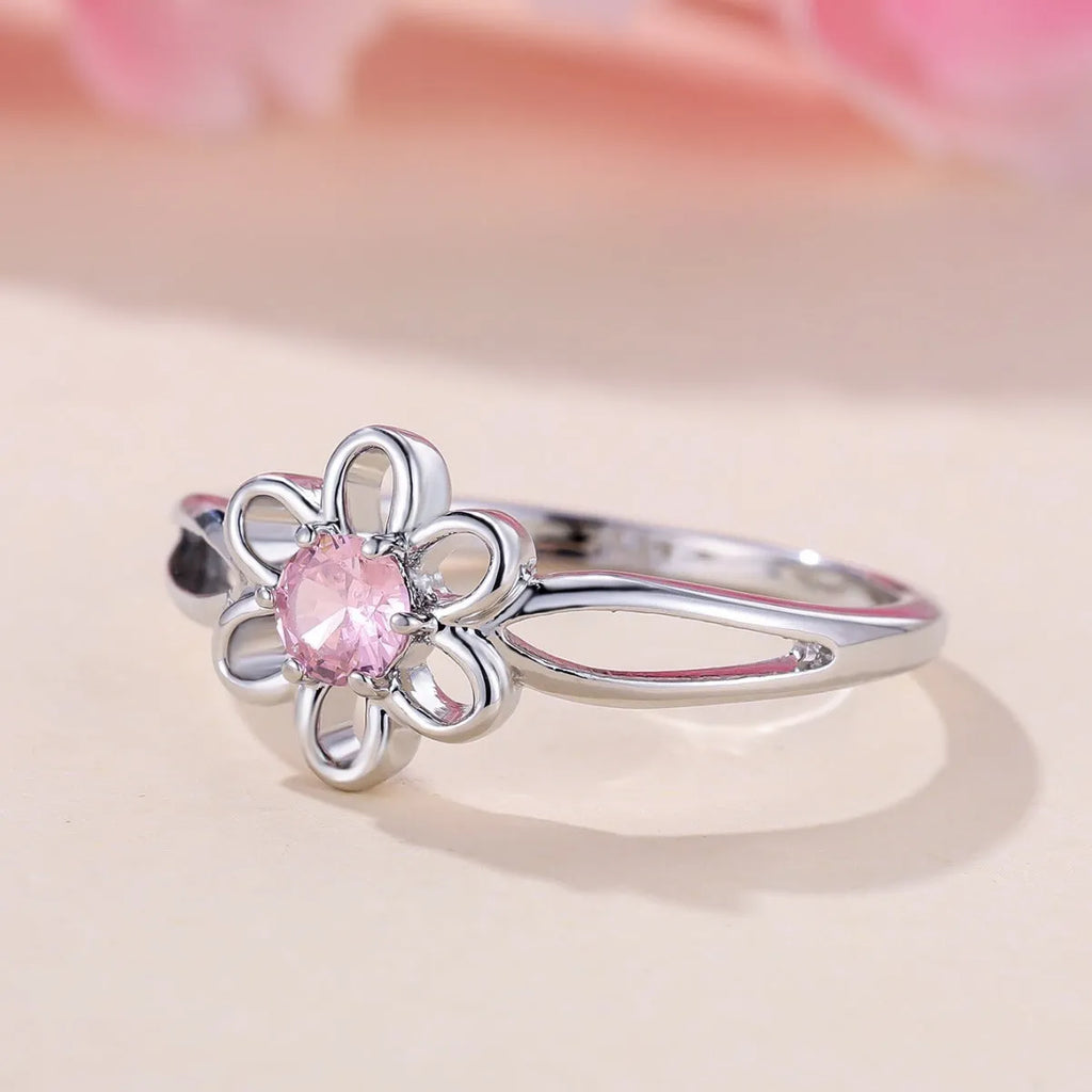 Women's hollowed floral copper ring with electroplated platinum pink diamond finish