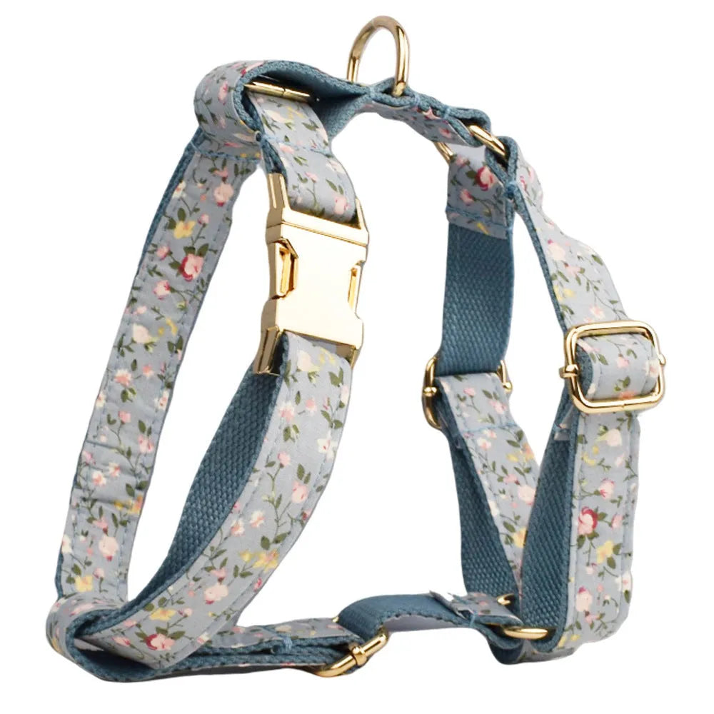 Blue floral patterned dog collar with matching accessories including leash, bow, vest, and poop bag