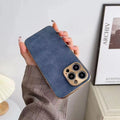 Leather texture iPhone case in grey, black, blue, and grey-green colours, shown on a compatible iPhone model.