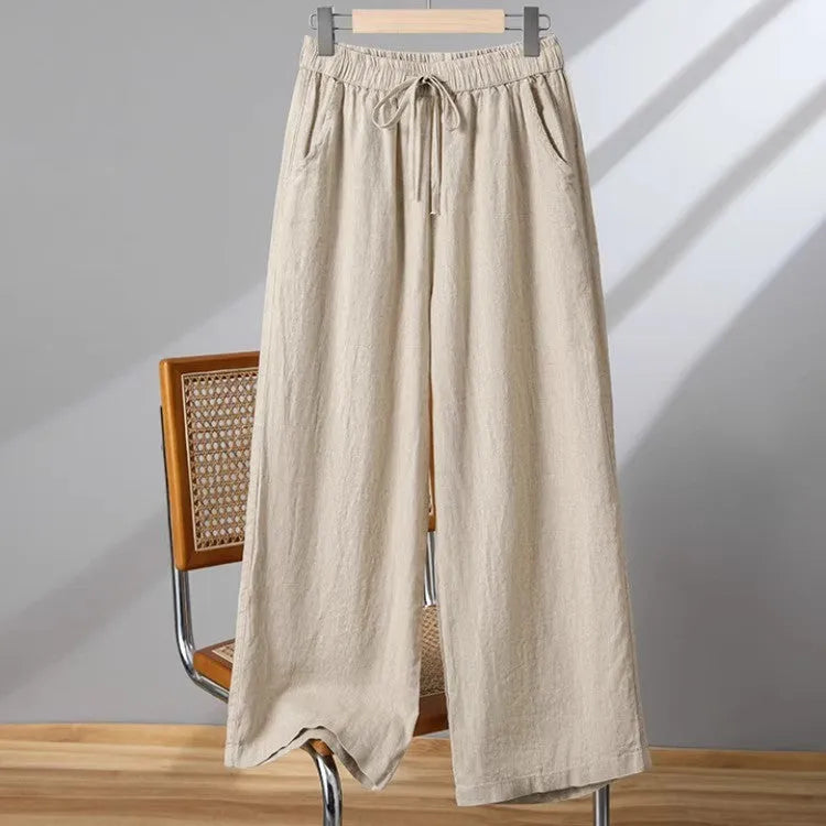 Women's apricot straight-leg casual trousers with a drawstring elasticated waist laid flat.