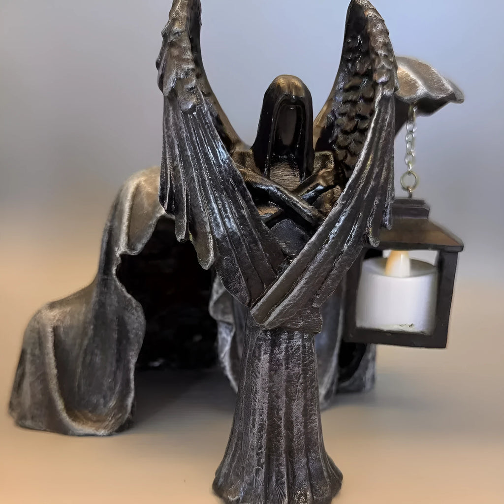 Dark coloured resin angel statue ornament with dimensions 6.5 cm by 5 cm by 17 cm.