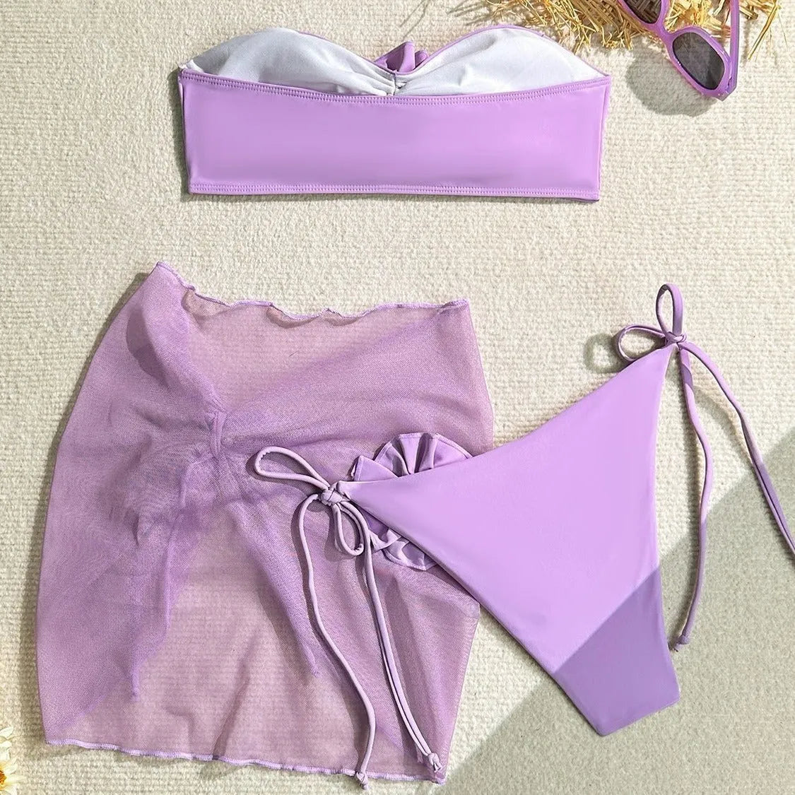 Women's pink tube top swimsuit with a large 3D flower tie and matching swim skirt.