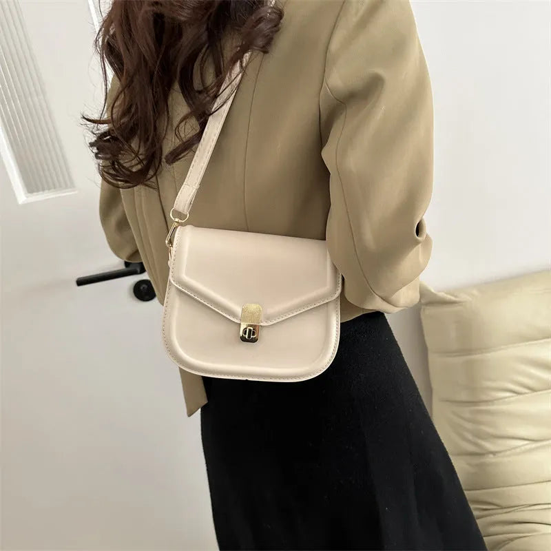 Soft textured PU leather messenger bag with clamshell opening in dark brown colour