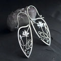 Silver lotus vine rhinestone earrings with geometric floral design