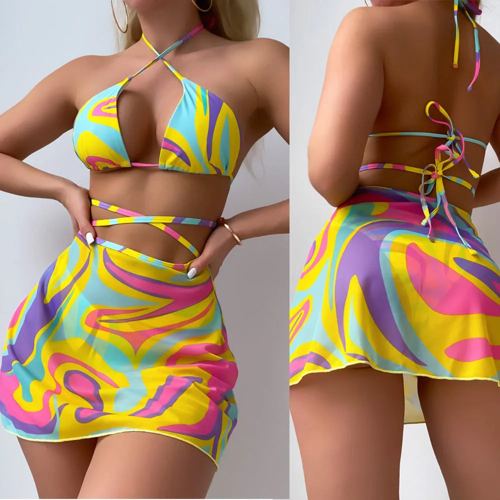 Yellow striped halter lace-up swimsuit for women with matching skirt and shorts.