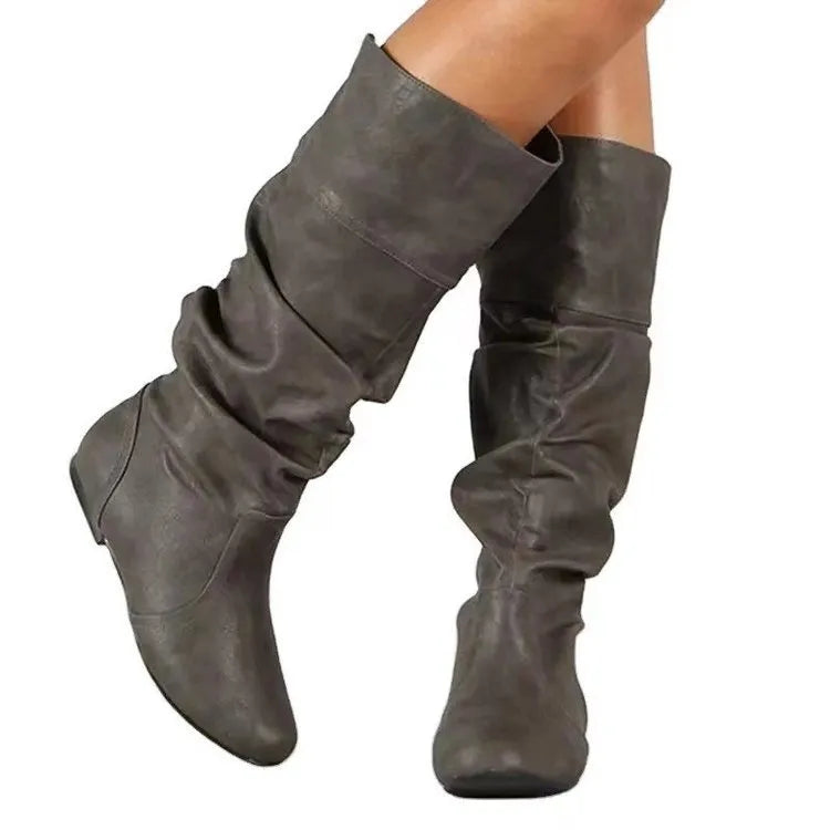 Women's black flat-heel slip-on ankle boots with round toe and high shaft on a rubber sole.