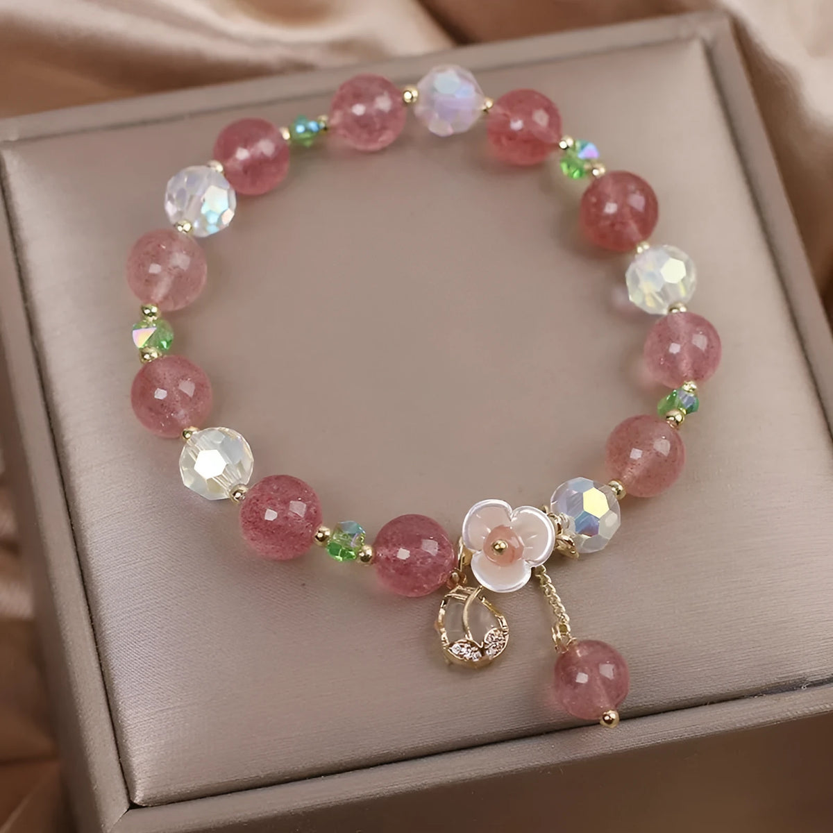 Double-layer strawberry quartz bracelet with lucky cat charm and red cat's eye flowers on adjustable fastening