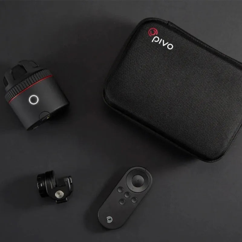 Matte black PIVO facial tracking camera on a 360-degree rotating base, attached to a smartphone.