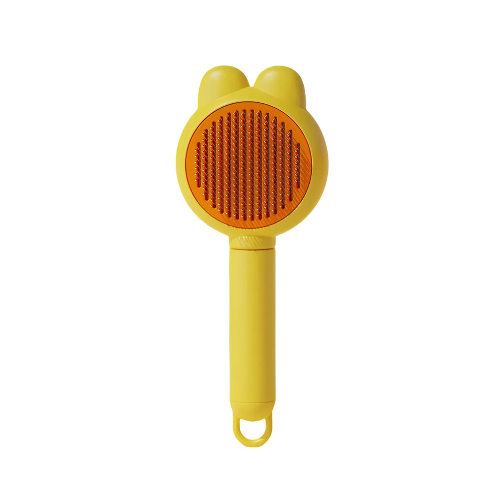 Self-cleaning pet brush with release button showing stainless steel comb teeth and coloured handle