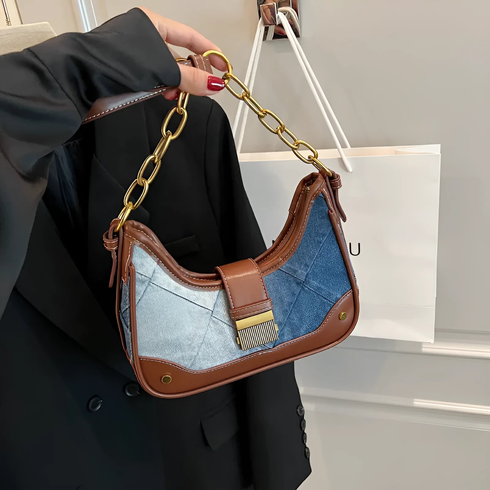 Brown denim women's shoulder bag with diamond mesh pattern and chain detail showing bucket shape