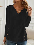 Simple solid colour knitted button sweater on hanger showing regular sleeves and button details