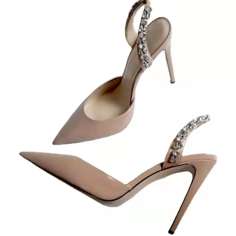 Women's black patent leather pointed toe high heel sandals with rhinestone detail on the side.