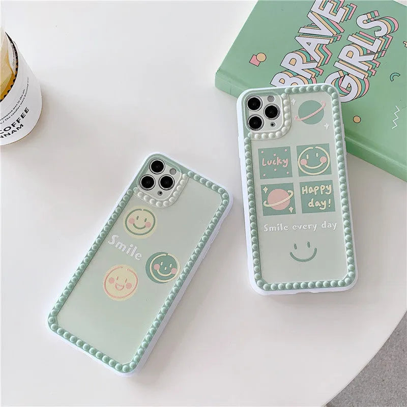 Green iPhone case with geometric smiley face design and polka dot frame on a TPU back cover.