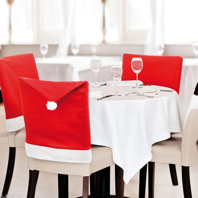 Set of red and white Christmas chair covers featuring Santa Claus, Snowman, and Santa hat designs on dining chairs.