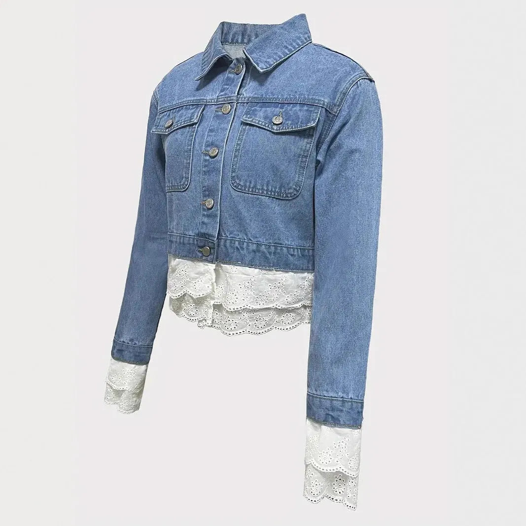 Blue women's denim jacket with lace stitching on the front, shown on a hanger.