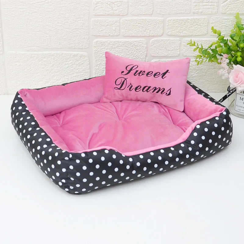 Polka dot printed cloth dog bed with matching embroidery pillow in grey, shown in a room setting.