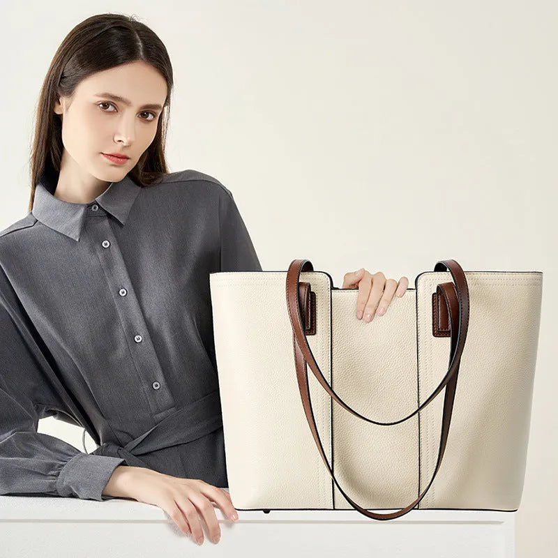 Women's black genuine leather horizontal square shoulder bag with crossbody strap showing internal organiser compartments.