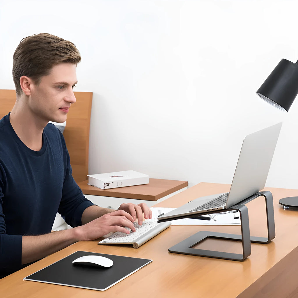 Black aluminium alloy laptop stand on a wooden desk