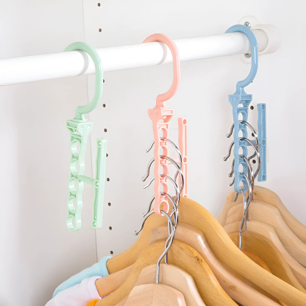 Blue plastic revolving wardrobe hanger with five branches and a top handle on a rail.