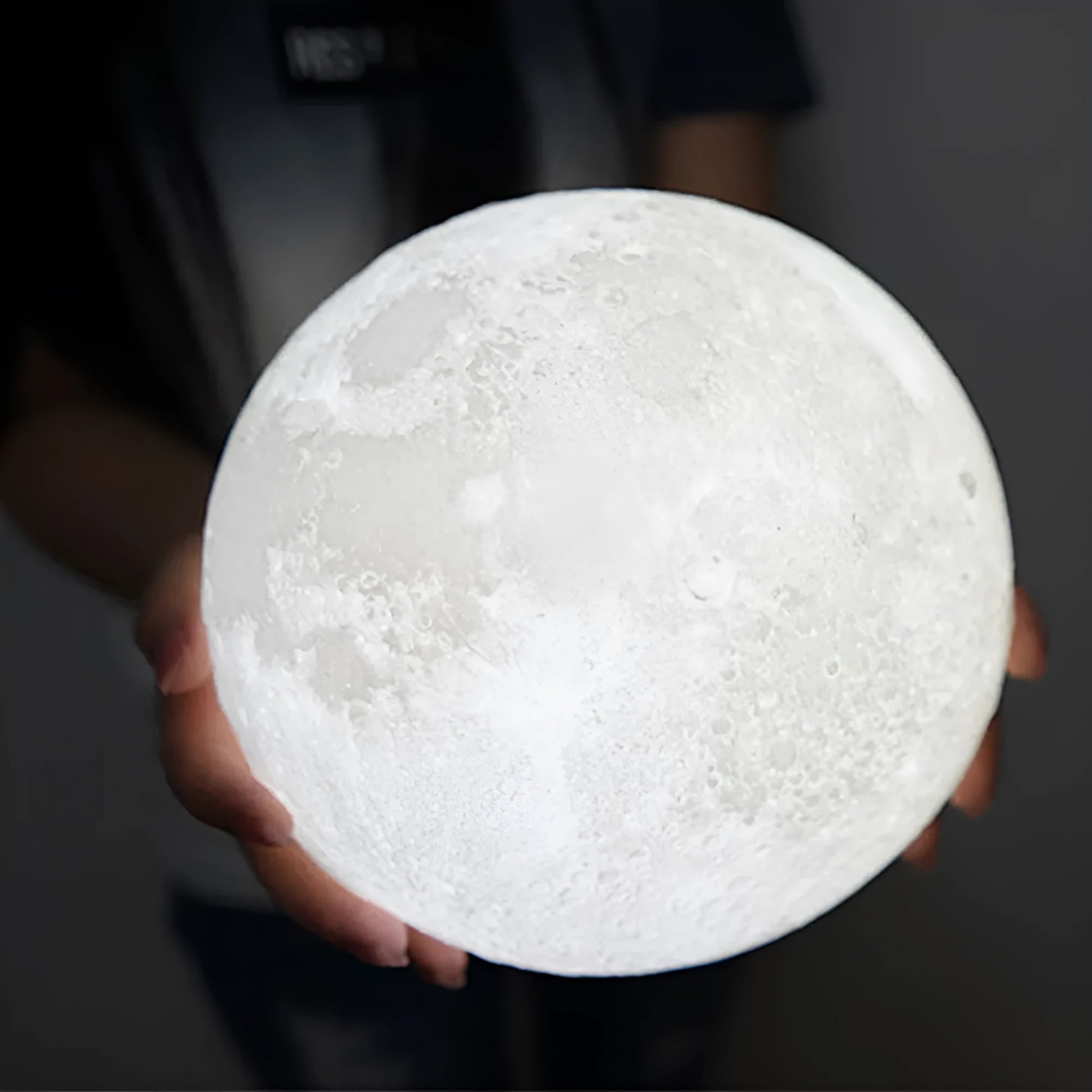 3D printed moon light lamp on wooden stand with detailed lunar surface, showing touch ring at base.
