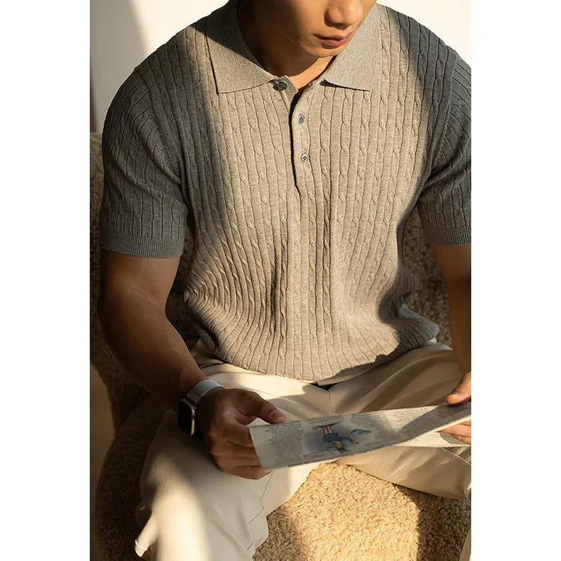 Men's khaki short sleeve business casual top on a hanger.