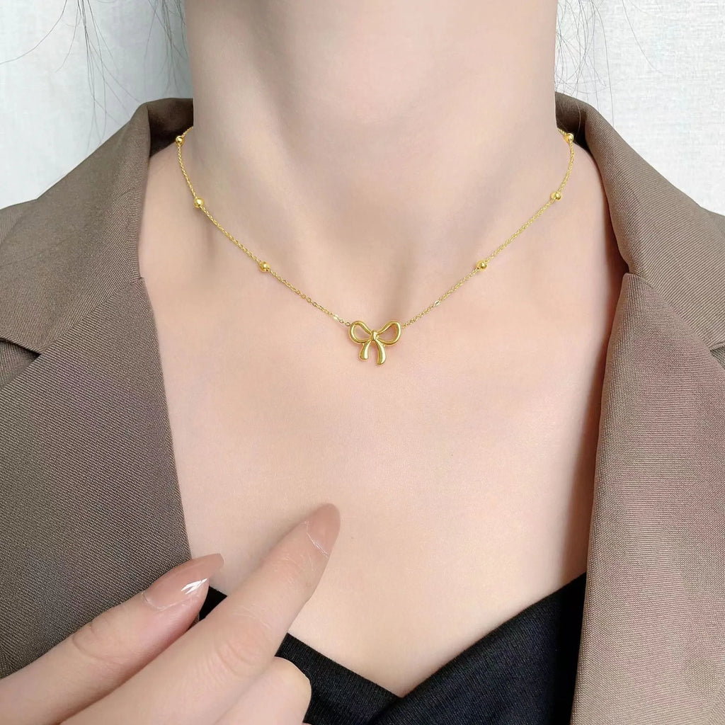 Gold electroplated bow necklace for women with titanium steel chain and adjustable length