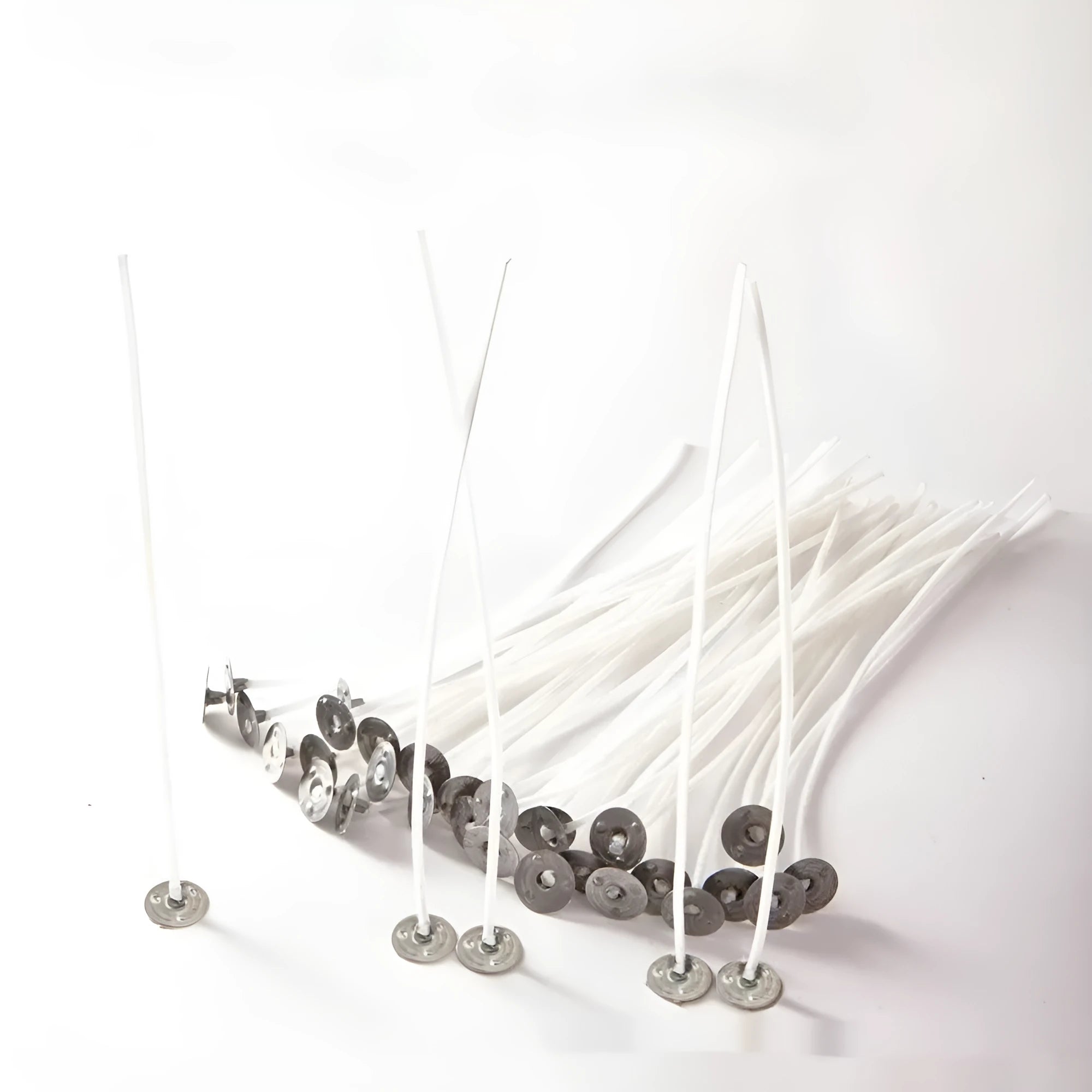 White cotton candle wicks showing tightly woven core construction in three length specifications