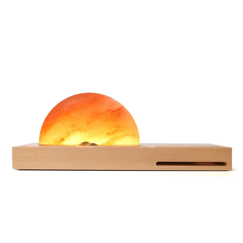 Natural crystal salt lamp on a beech wood base with integrated wireless phone charging pad.
