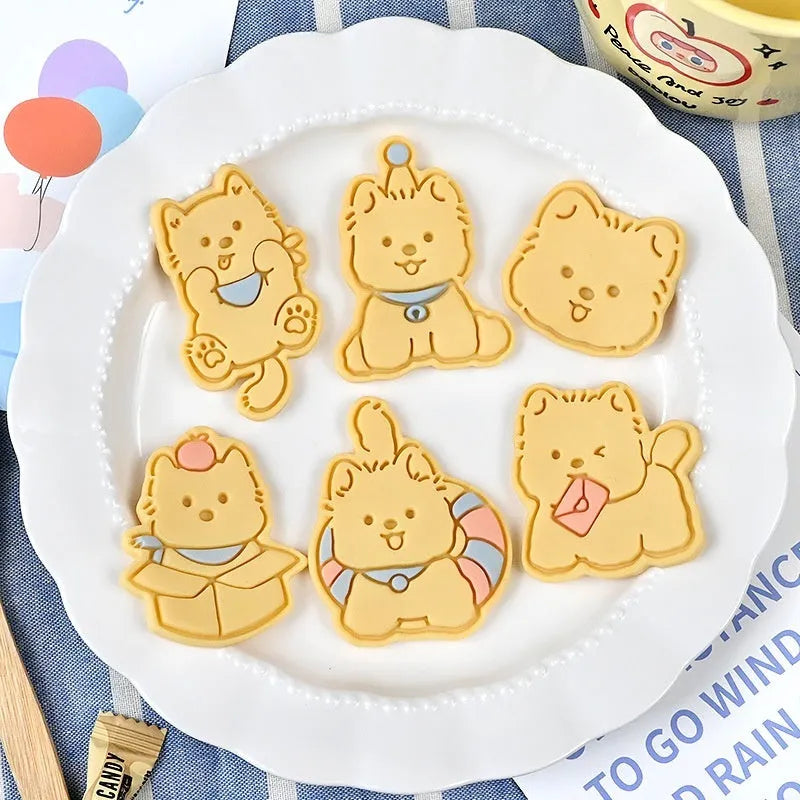 Plastic 3D biscuit mould with cartoon puppy designs including birthday hats and swimming rings