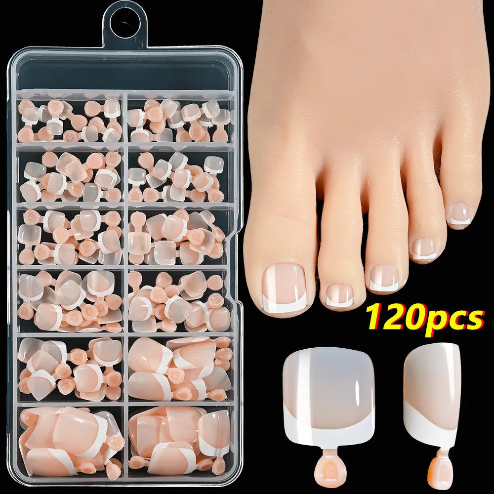 120 piece box of square short French style artificial toe nails with white tips on nude base.