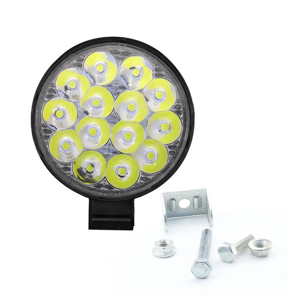 Compact round 42W LED work light with aluminium housing for car, truck, or motorcycle.