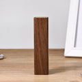 Brown walnut wood portable power bank with USB port next to its gift box.