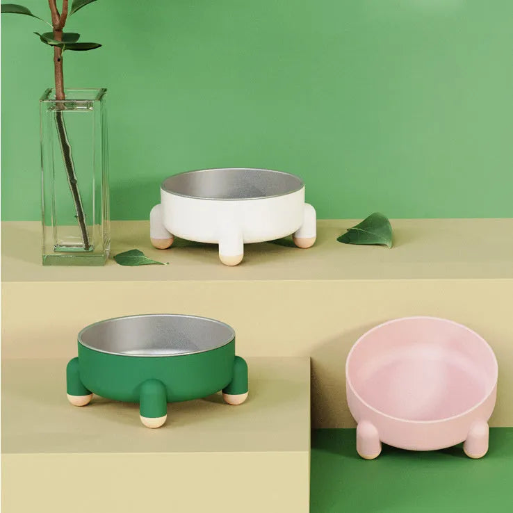Green non-slip stainless steel pet food bowl with a high foot, shown on a floor.