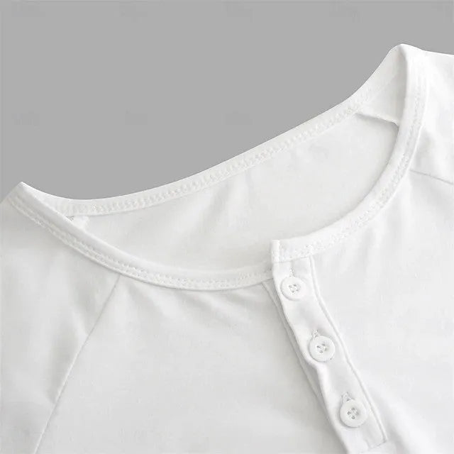 Man wearing a white long-sleeved t-shirt with a Henry collar.
