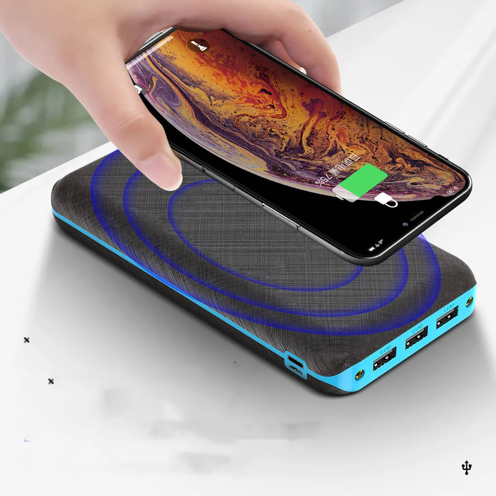 Black solar power bank with wireless charging pad, three USB ports, and an LED flashlight.